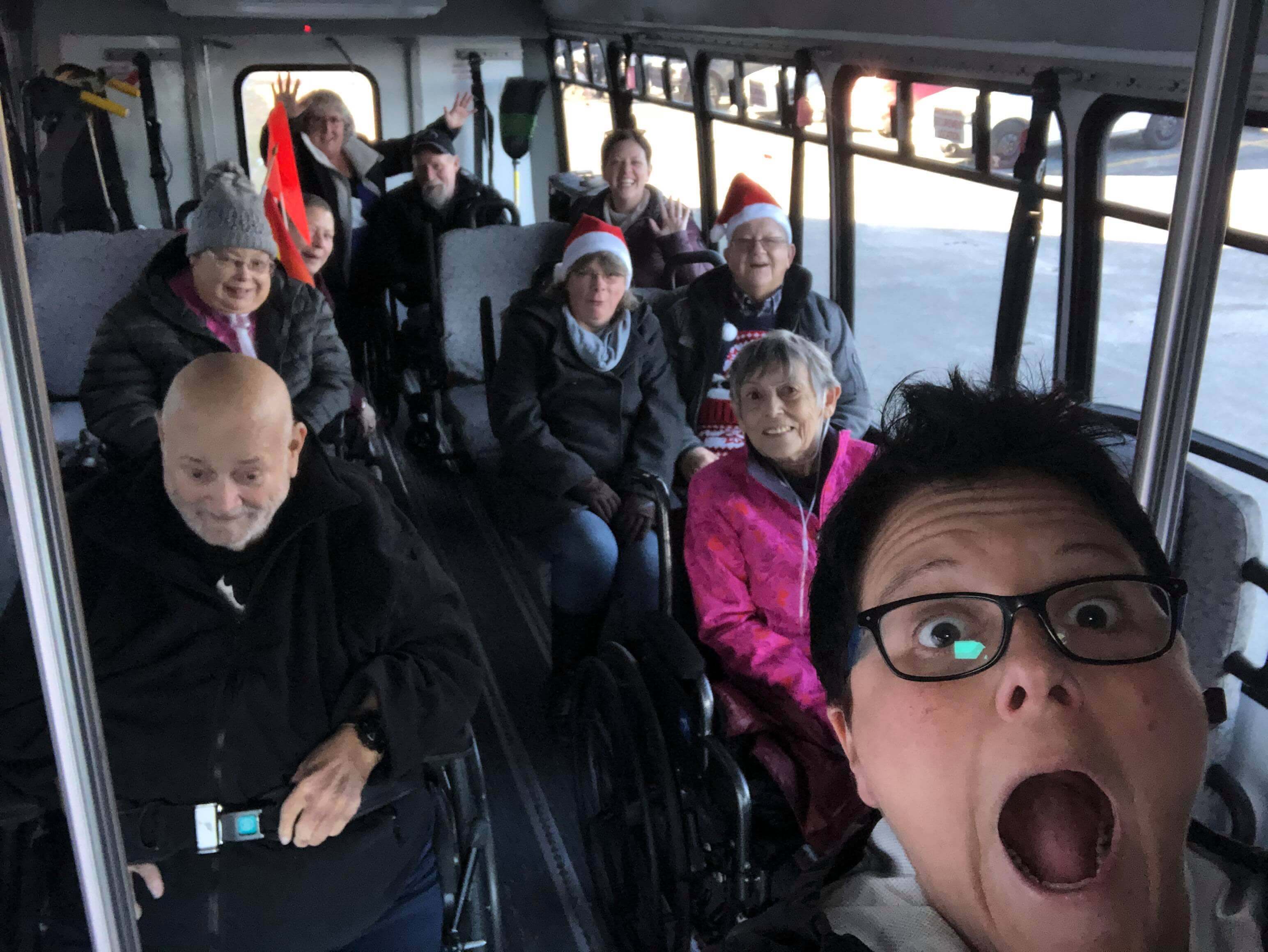 Dianne and Susan with seniors going to Glow Park while on accessible bus