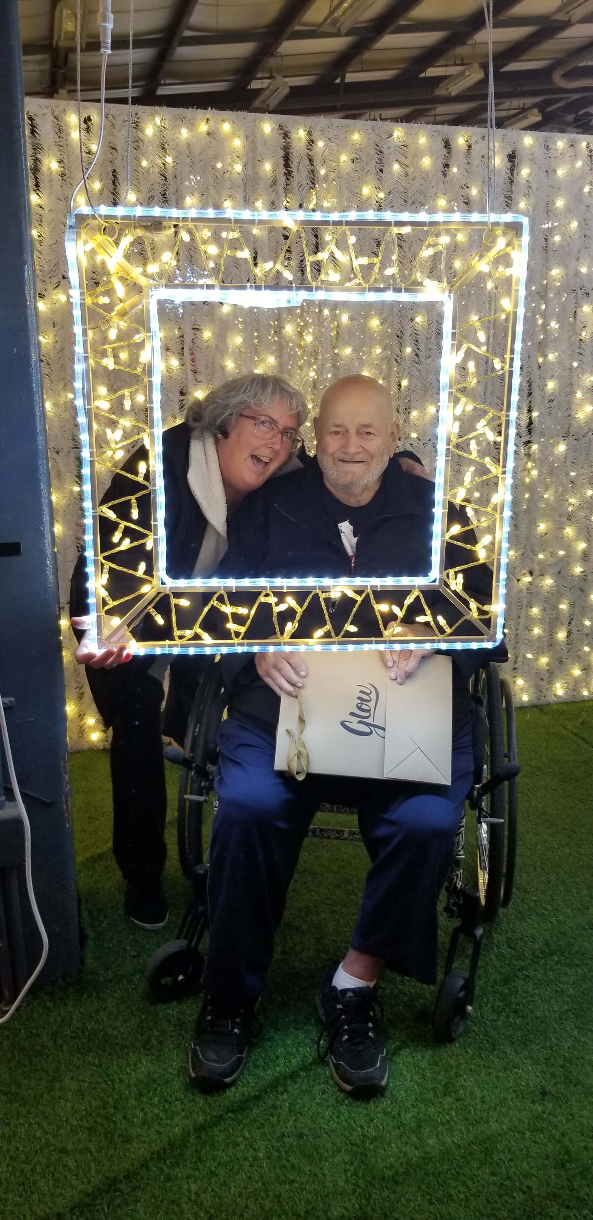 Owner Susan and senior male posing in glow picture frame
